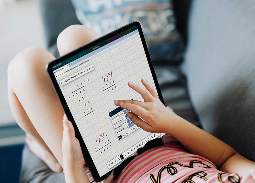 A child on a couch working a long division problem in Modmath on a tablet.