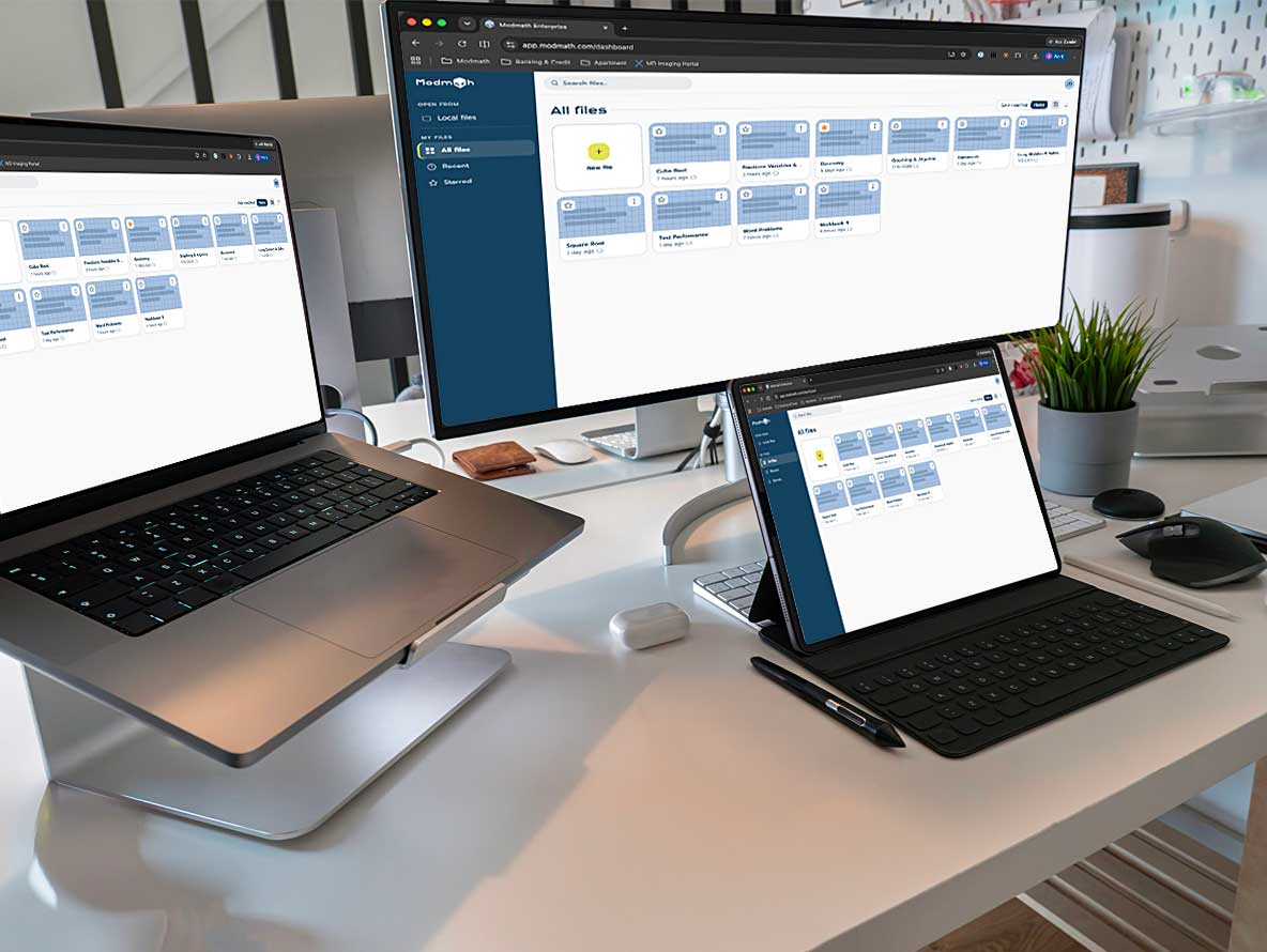 Modmath open on a MacBook, an external monitor, and an iPad on the same desk, each showing the saved-files dashboard.